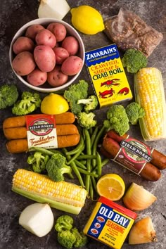 an assortment of food including potatoes, broccoli, carrots and corn on the cob