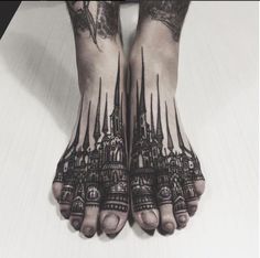 a person with tattoos on their feet and hands