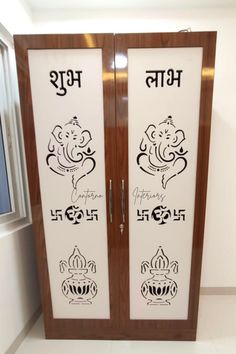 two glass doors with the words ganesh and ganeshi on them in front of a window