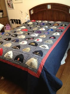 a bed with a blue bedspread covered in lots of different types of patches