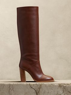 Sturdy and sophisticated, this knee-high boot delivers a timeless silhouette destined to endure the seasons thanks to a design free from ornamentation and exquisite craftsmanship by master Italian cobblers.  PREMIUM LEATHER: This item is crafted using vegetable-tanned leather, an intricate and lengthy artisanal process that turns the finest hides into truly one-of-a-kind leathers that soften, burnish and develop dimensional finishes with wear.  HOW IT FITS: Semi-fitted.  Slim through the calf.  Pull on style, may not be suitable for those with high arches.  Italian leather uppers, leather lining and leather soles.  Stacked heel.  Made in Italy.  HOW IT FITS: Semi-fitted.  Slim through the calf.  Pull on style, may not be suitable for those with high arches.  B width.  Knee high.  Heel heig Elegant Tall Boots For Fall, Classic Knee-high Heeled Boots With Leather Lining, Elegant Tall Leather Knee-high Boots, Elegant Tall Brown Boots, Elegant Tall Mid-calf Boots For Fall, Elegant Tall Boots For Formal Occasions, Luxury Knee-high Boots With Leather Sole, Classic Leather Knee-high Boots With Sculpted Heel, Classic Leather Knee-high Boots