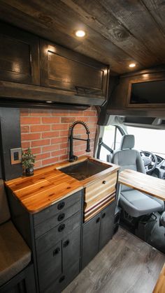 the kitchen is made out of wood and has a sink