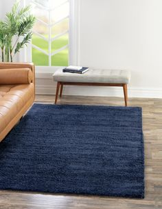 a living room with a couch, coffee table and rug