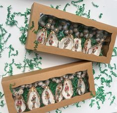 two boxes filled with ornaments on top of a table