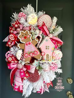 a christmas wreath with gingerbreads, candy canes and decorations hanging from the front door