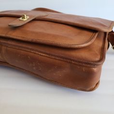 "Vintage Coach Original Metropolitan Brief Bag British tan leather with brass hardware Roomy interior with inner slip pocket, one outer pocket covered by a flap and secured by a turnlock Top handle Full back pocket Adjustable 46\" strap Measures: 15\"L, 11\"H, 2\"W Made in the United States #0348 928 Flaws: minor pen marks on inner flap and a few on front flap Questions? Just ask More vtg coach styles/colors also available" Classic Brown Crossbody Flap Bag, Cognac Rectangular Bag With Turn-lock Closure, Classic Brown Shoulder Flap Bag, Classic Cognac Shoulder Bag With Gold-tone Hardware, Cognac Travel Bag With Brass Hardware, Classic Everyday Flap Bag With Leather Lining, Timeless Satchel With Turn-lock For Everyday Use, Classic Flap Bag With Leather Lining For Everyday, Classic Brown Saddle Bag With Adjustable Strap