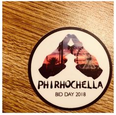 a sticker that says phhrochella bid day on the side of a wooden table