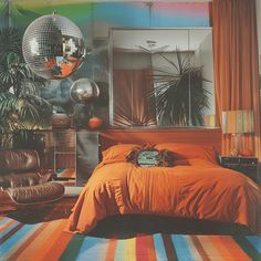 a bed room with a neatly made bed and disco ball decorations