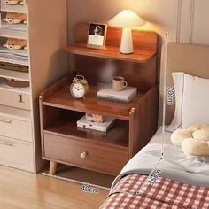 a bed room with a neatly made bed and a night stand next to the bed