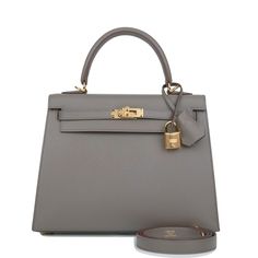 This Kelly, in the Sellier style, is in Etain epsom leather with gold hardware and has tonal stitching, two straps with front toggle closure, clochette with lock and two keys, a single rolled handle and removable shoulder strap. The interior is lined with Etain chevre leather and has one zip pocket with an Hermes engraved pull and one open pocket on the opposite side. Collection: ZOrigin: FranceCondition: New (plastic on hardware)Accompanied by: Hermes box, Hermes dustbag, clochette, lock, two k Kelly 25, Grey Leather, Leather Satchel, Satchel