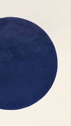 a blue and white circular painting on the wall