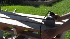 a person is sanding up some wood with an electric sander on top of it