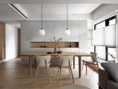 a dining room table surrounded by white chairs