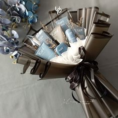 a bouquet of blue and white flowers with chocolates in the middle on a table