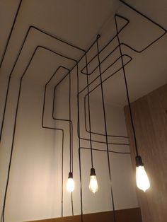 several light bulbs are hanging from the ceiling