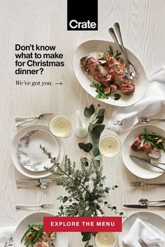 a table with white plates and silverware on it that says, don't know what to make for christmas dinner? we've got you explore the menu