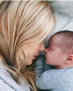 a woman holding a baby in her arms with the caption pregnant with nail's baby boy