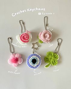 four crochet keychains with different colors and designs on them, including an eye