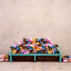 a blue couch sitting on top of a cement floor