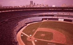 an aerial view of a baseball stadium with the city in the background