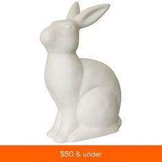 a white rabbit statue sitting on top of an orange and white sign that says $ 50 & under