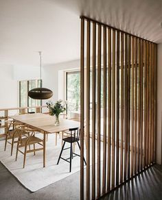 a dining room with wooden slats on the wall