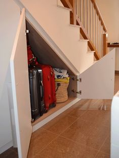 an open closet under the stairs in a house