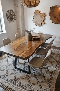 a dining room table with chairs and a rug on the floor in front of it