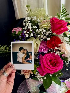 a bouquet of flowers with a photo frame in the middle