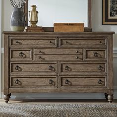 a dresser with drawers and a mirror on top