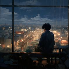 a man sitting on top of a window sill looking out over a city at night