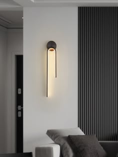 a modern light fixture mounted on the wall in a living room