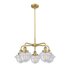 three light chandelier with clear glass shades on the bottom and gold metal frame