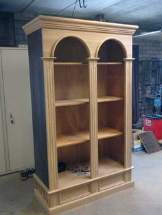 a large wooden bookcase in a garage