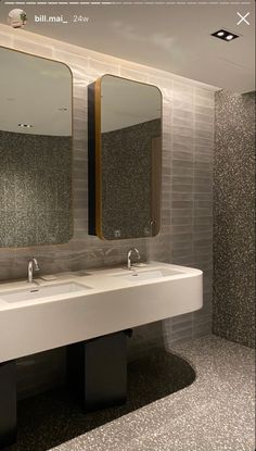 a bathroom with two sinks and mirrors in it