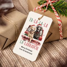 two dogs are sitting in the back of a red truck with presents wrapped around it