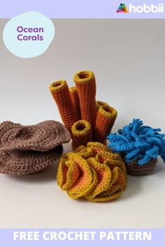 several crocheted objects are arranged on a white surface with the words ocean corals above them