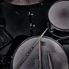 a drum set with two sticks sticking out of it