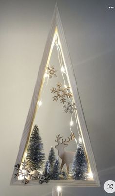 a christmas tree with lights in the shape of a triangle