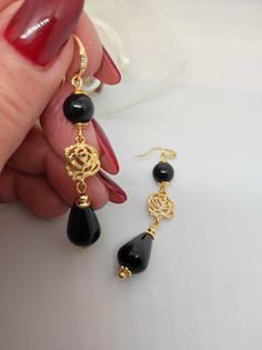 Beautiful handmade earrings with black agate beads and 18K gold plated metal components. For this creation I was inspired by the classic 50s style. I used the contrast of gold and black colors which makes the earrings very elegant. The earrings are long, very elegant and romantic thanks to the floral elements as connectors. Suitable for an elegant evening dress for an important party. They match with some long agate necklaces that I offer in my shop. All jewels are delivered in a decorated box, ready to be given as a gift to your loved one. How to take care of your jewellery: put on your beauty products (cosmetics, perfumes, ...) before wearing your precious jewel. Clean your jewelry with a soft cloth after wearing. Don't use water. Make sure you store your jewelry separately to avoid scra Elegant Onyx Earrings, Elegant Onyx Earrings For Party, Gold Onyx Earrings For Evening, Black Beads Drop Earrings For Evening, Black Beaded Drop Earrings For Evening, Black Gold-plated Pierced Earrings, Black Gold-plated Earrings, Evening Black Beaded Drop Earrings, Onyx Earrings For Evening