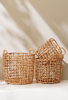 two wicker baskets sitting next to each other