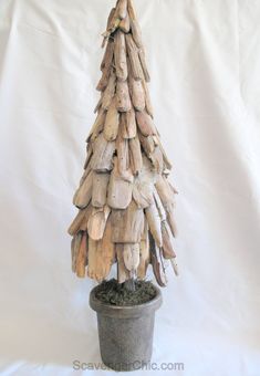 a small tree made out of driftwood sitting in a pot