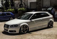 a white car parked in front of a building