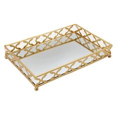 a gold and white tray with an ornate design on the bottom, in front of a white background