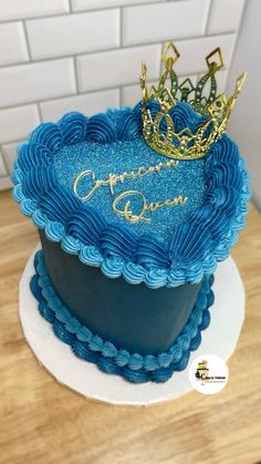 a blue cake with a crown on top