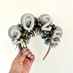 🪩New Years Eve 2025 celebration headband.  🪩Celebrate in style and make a statement with this big bold sparkly 2025 headband.  🪩The headband has been made on a satin headband with sparkly silver big balls, holographic and black tinsel with pearl 2025 across the front.  🪩 Please choose a white or black headband.  🪩 Other styles and colour options available in the shop. 🪩 These can also be made with your year of birth - please leave a note or message me directly. Satin Headband, Big Balls, Black Headband, Party Celebration, Eve Parties, New Years Eve Party, Nouvel An, Celebration Party, Party Hats