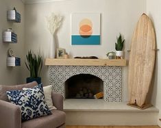 a living room with a surfboard on the wall and a fire place in the corner