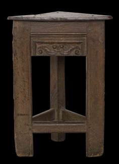 an old wooden table with a marble top on it's legs and bottom shelf