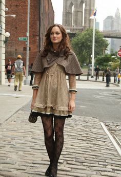 a woman is walking down the street wearing tights and stockings with her hands in her pockets