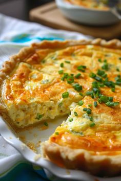 a quiche on a plate with one slice missing